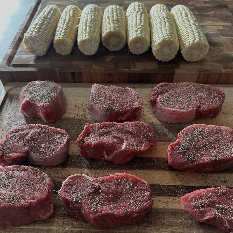 Steaks and corn on the board before dinner