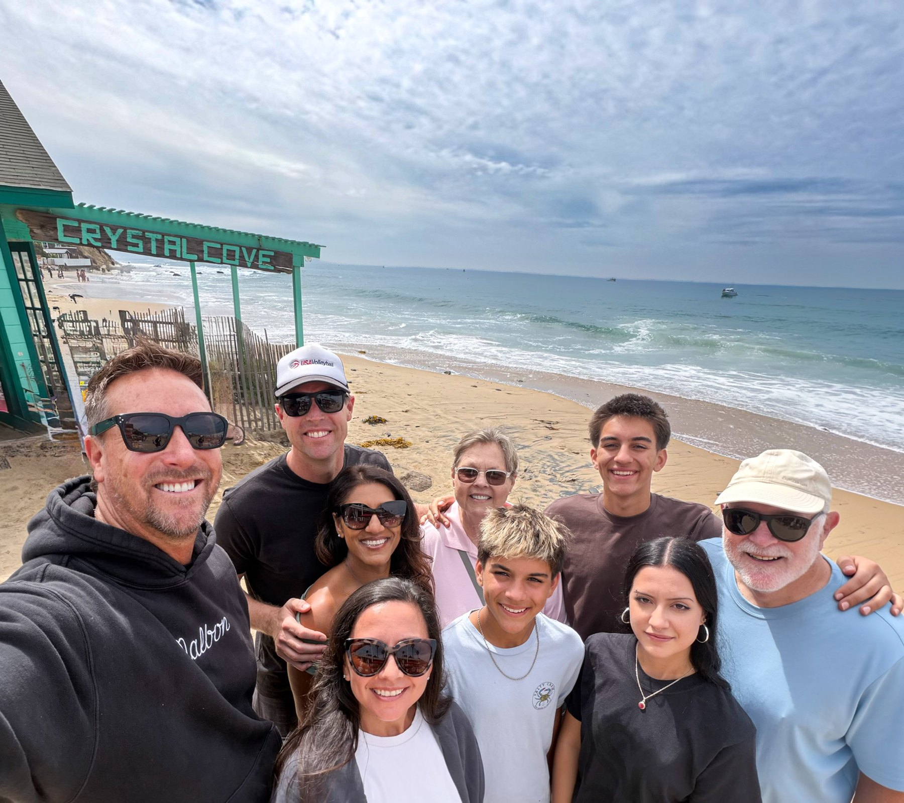 The family at the Crystal Cove sign